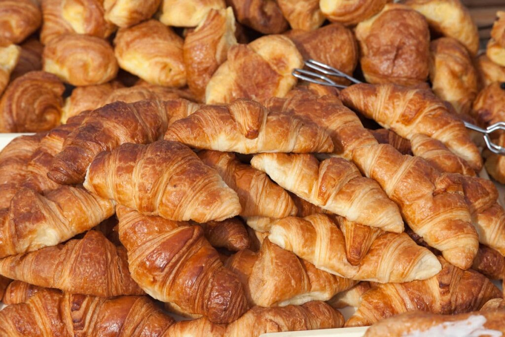Close up shot of a pile of croissants.