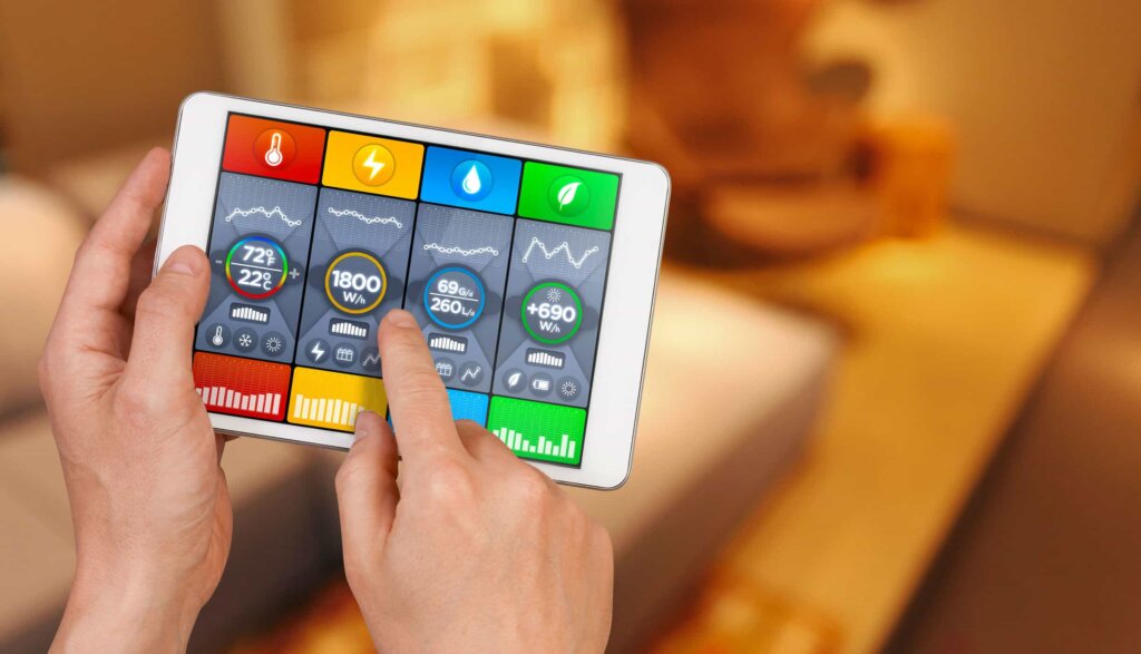 Hands holding tablet with smart thermostat application on screen